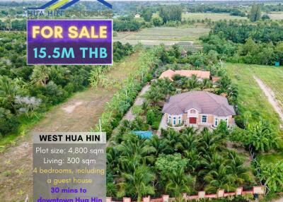 Aerial view of a property with a house and surrounding greenery