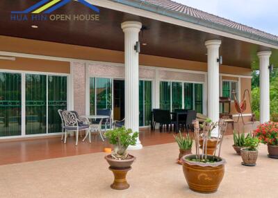 Outdoor patio area with seating and potted plants