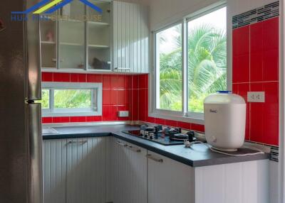 Modern kitchen with red and white tiles