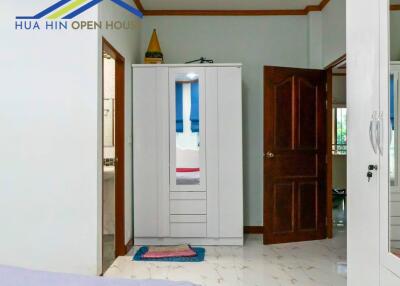 Bedroom with open door and wardrobe