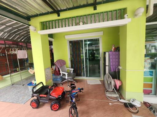 Covered outdoor area with toys and furniture