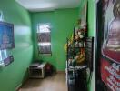 Small room with green walls and Buddhist decor