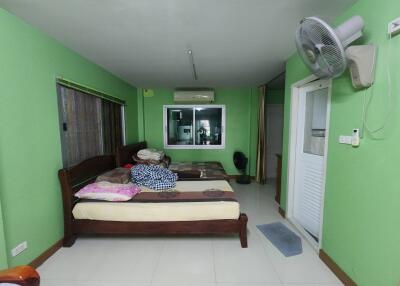 Bedroom with green walls and large bed