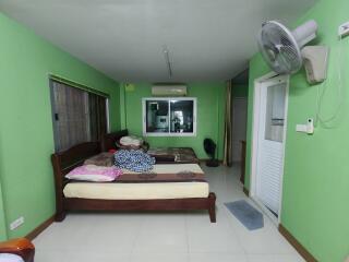 Bedroom with green walls and large bed