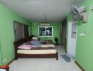 Bedroom with green walls and large bed