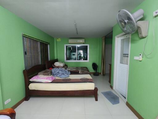 Bedroom with green walls and large bed