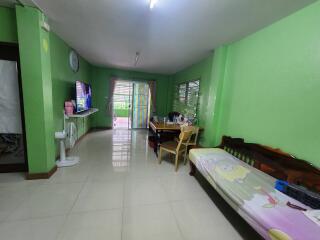 Bright living room with green walls and tiled floor