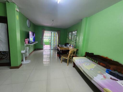 Bright living room with green walls and tiled floor