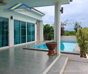 Outdoor space with pool and seating area