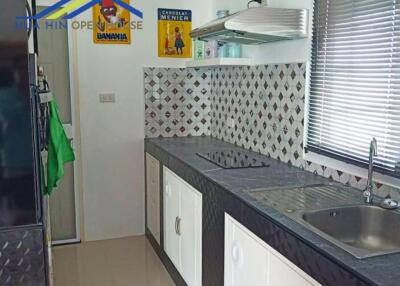 Modern kitchen with black countertop and white cabinets