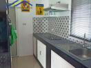 Modern kitchen with black countertop and white cabinets