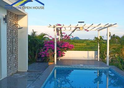 Lovely pool area with pergola and surrounding greenery