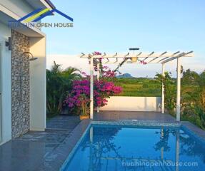 Lovely pool area with pergola and surrounding greenery