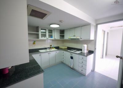 Modern kitchen with white cabinets and black countertops