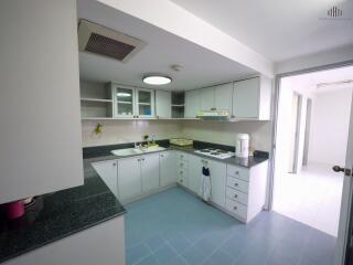 Modern kitchen with white cabinets and black countertops