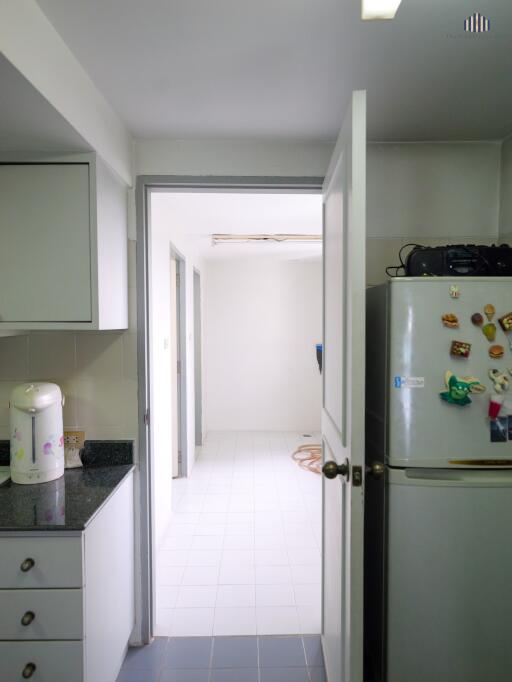 Modern kitchen with doorway to additional room or space