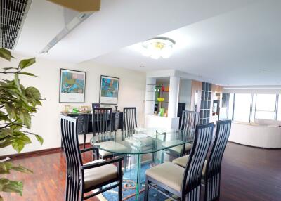 Spacious and modern dining area with a large glass table and stylish chairs