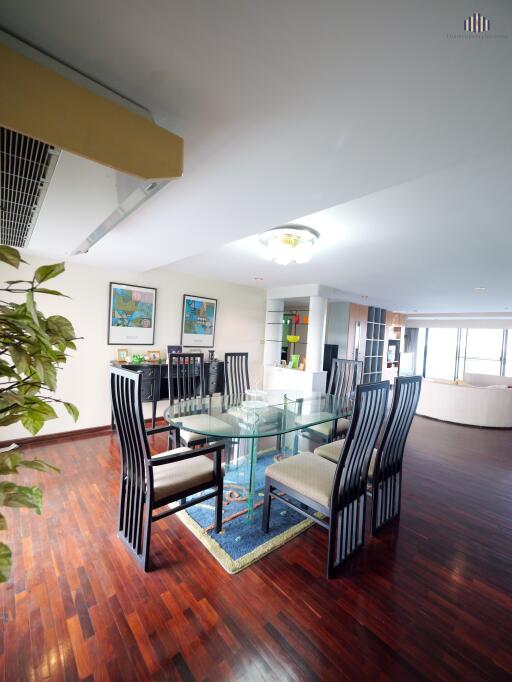 Spacious and modern dining area with a large glass table and stylish chairs