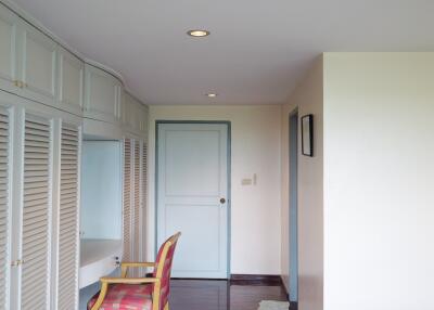 Bedroom hallway with built-in wardrobes and a sitting area