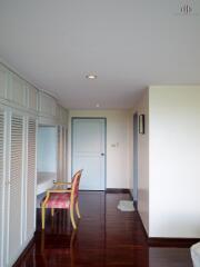 Bedroom hallway with built-in wardrobes and a sitting area