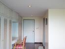 Bedroom hallway with built-in wardrobes and a sitting area