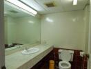 Bathroom with large mirror and tiled walls