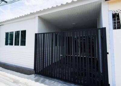 Exterior view of a property with a gated driveway