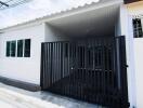 Exterior view of a property with a gated driveway