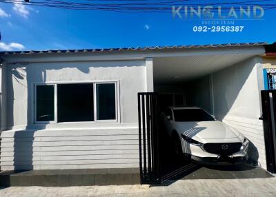 Front view of a house with a car parked in the garage