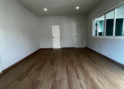 Spacious living area with wooden flooring