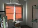 Small bedroom with air conditioner and storage items