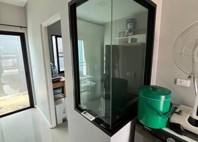 Modern apartment interior with a glass window and green container