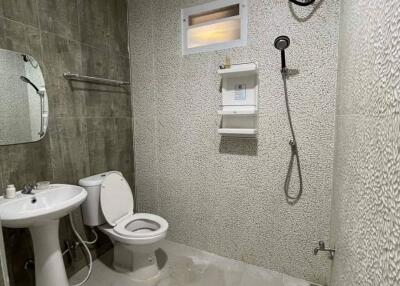 Bathroom with sink, toilet, mirror, shower and water heater