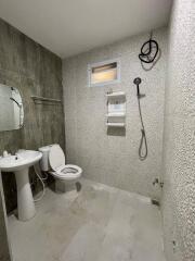 Bathroom with sink, toilet, mirror, shower and water heater