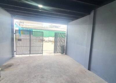 Empty garage with an open metal gate