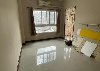 Empty bedroom with large window and air conditioning