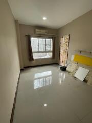 Empty bedroom with large window and air conditioning