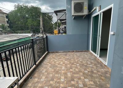 Spacious balcony with outdoor tiles and railing