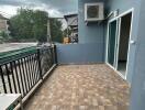 Spacious balcony with outdoor tiles and railing