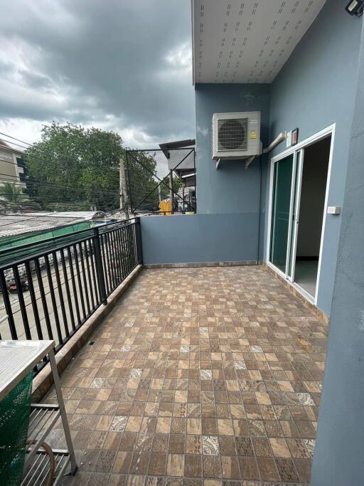 Spacious balcony with outdoor tiles and railing