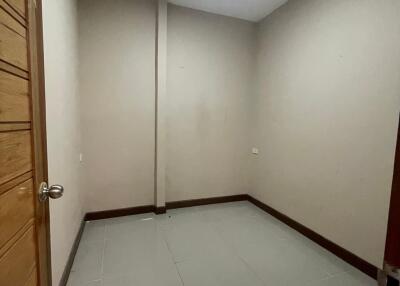 empty room with tiled floor and wooden door