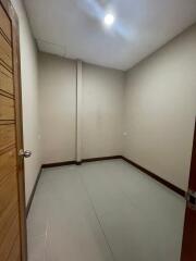 empty room with tiled floor and wooden door