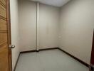 empty room with tiled floor and wooden door