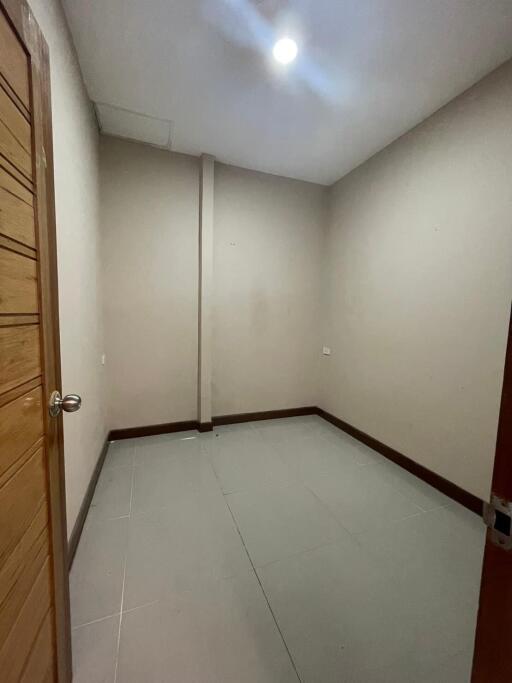 empty room with tiled floor and wooden door