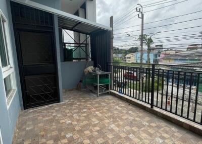 Spacious balcony with tiled floor and black railing