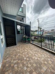 Spacious balcony with tiled floor and black railing