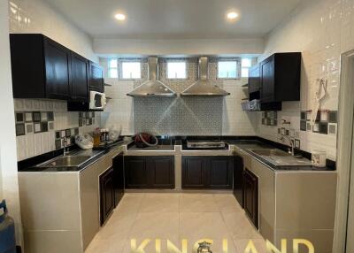 Modern kitchen with dark cabinetry and tiled backsplash