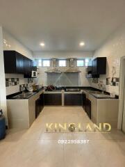 Modern kitchen with dark cabinetry and tiled backsplash