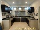 Modern kitchen with dark cabinetry and tiled backsplash