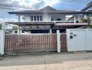 Front view of a house with a gated entrance